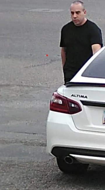 Color security camera photo of suspect with his associated vehicle