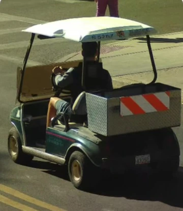 Color photo of suspect driving golf cart